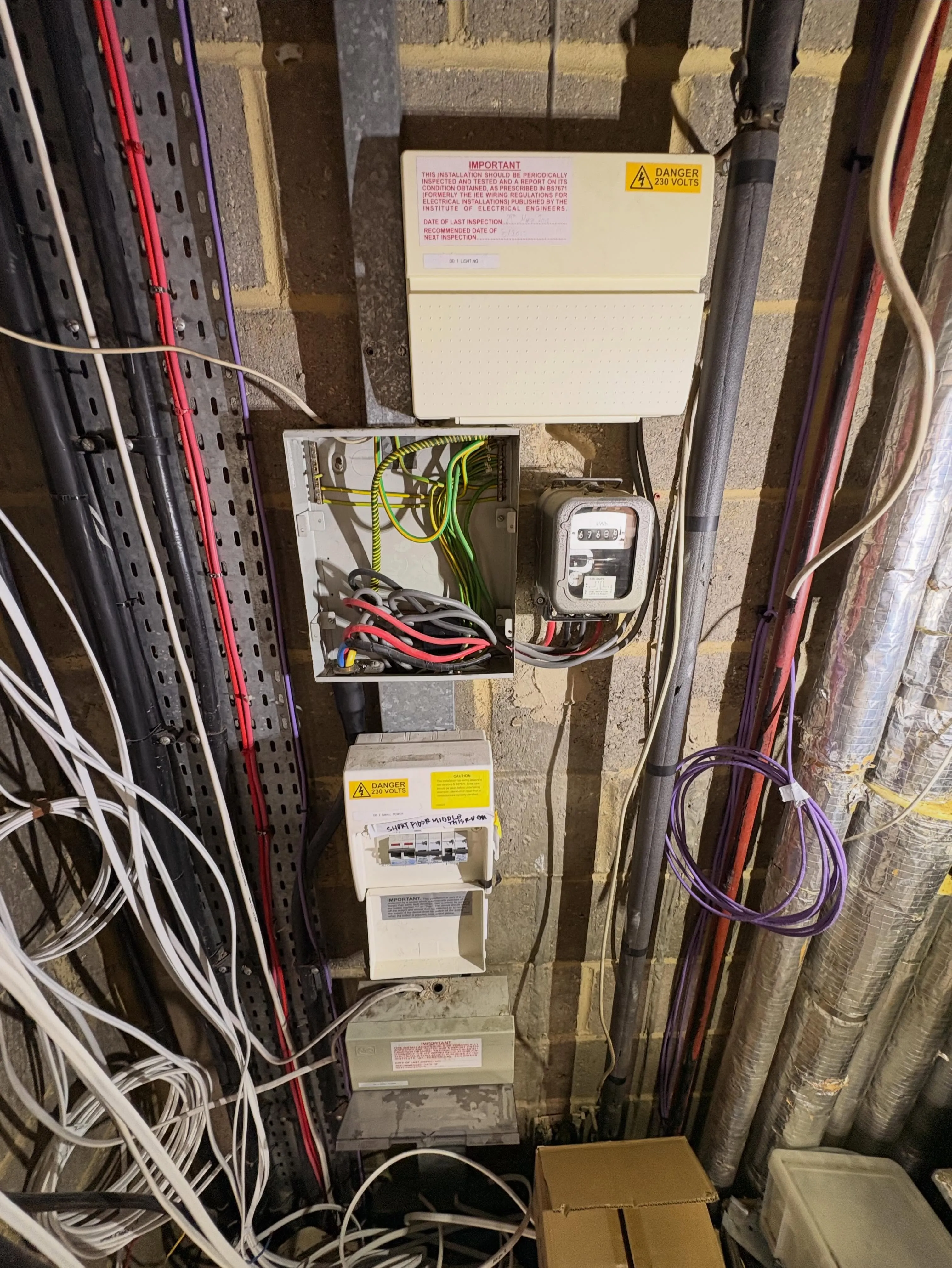 Existing commercial distribution board with a periodic inspection label, meter and circuit labelling
