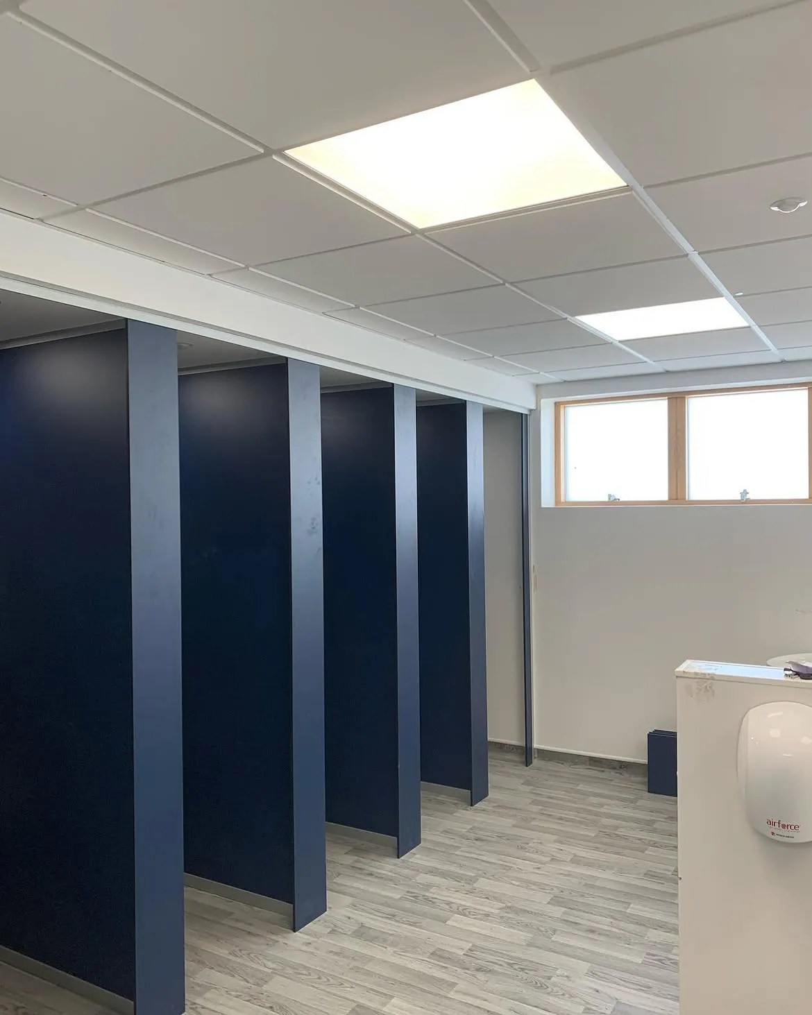 Refurbished school washroom with new Luceco LED panel lighting on PIR control