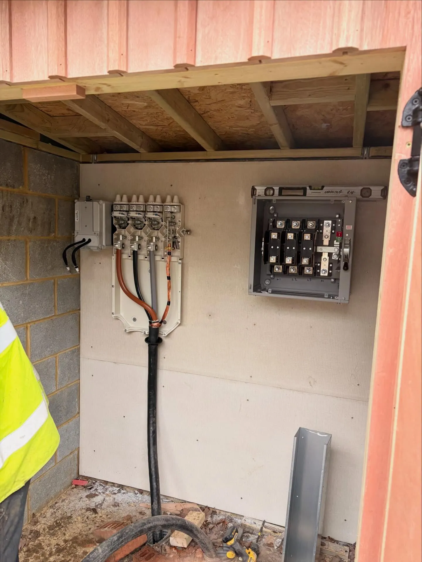 Three-phase intake with DNO cut-outs and a switch-fuse mounted on a plywood backboard